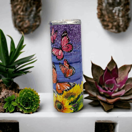 20oz tumbler with purple background featuring orange and pink butterflies and vibrant sunflowers design