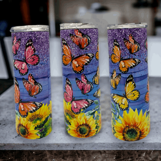 20oz tumbler with purple glitter top, blue background, colorful butterflies, and bright sunflowers design