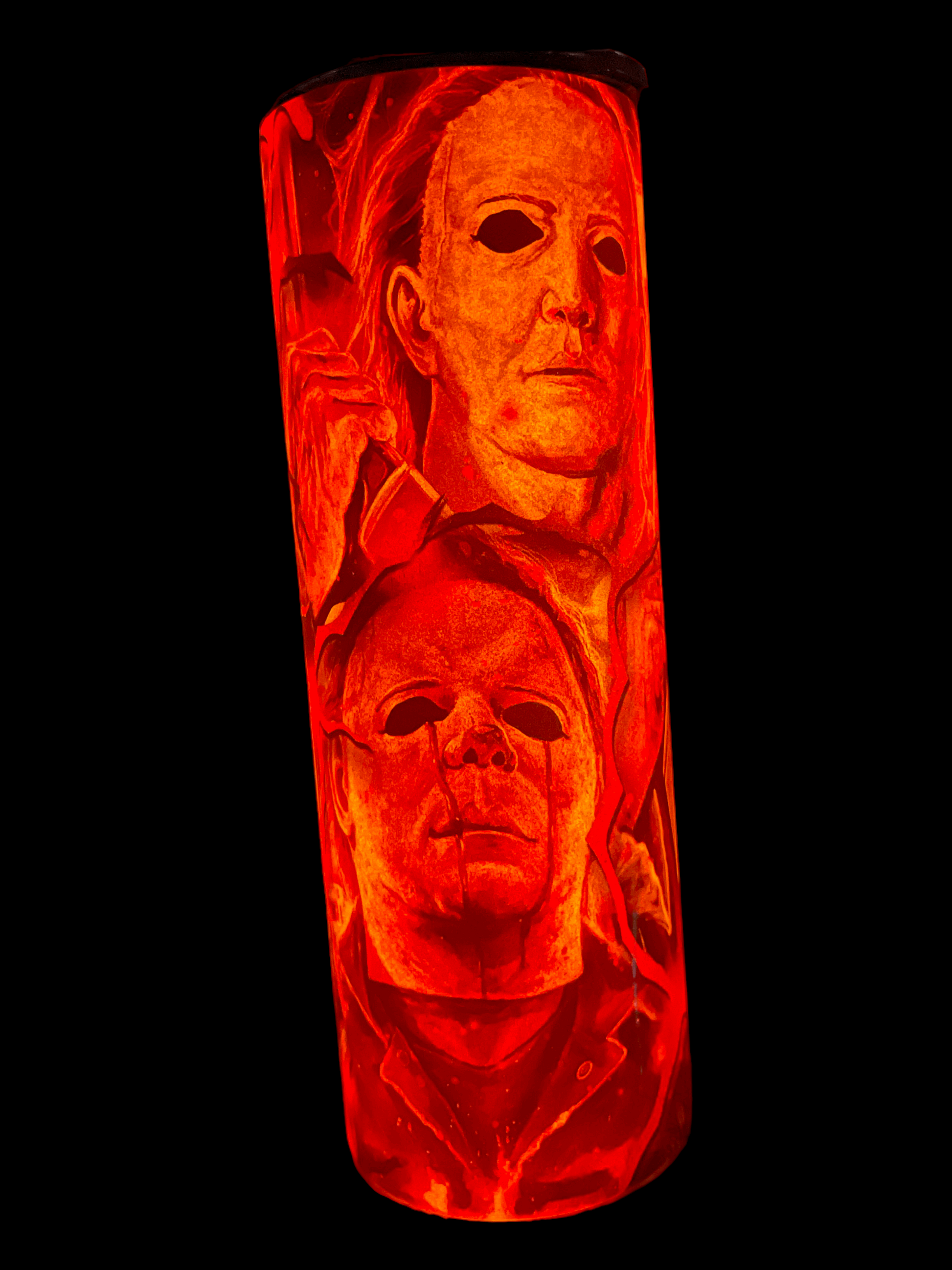 20oz tumbler featuring michael myers in halloween design with red and orange horror-themed artwork