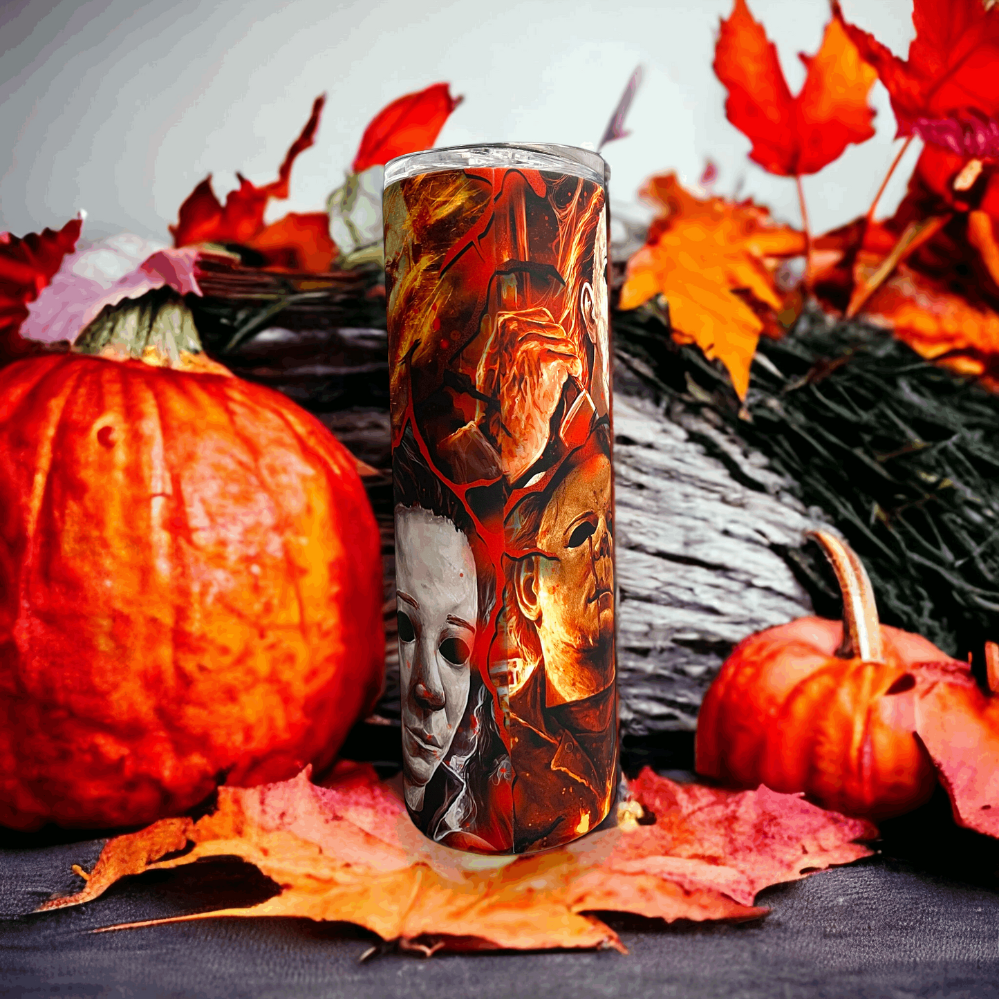 20oz tumbler featuring michael myers in halloween design with autumn leaves and pumpkins backdrop