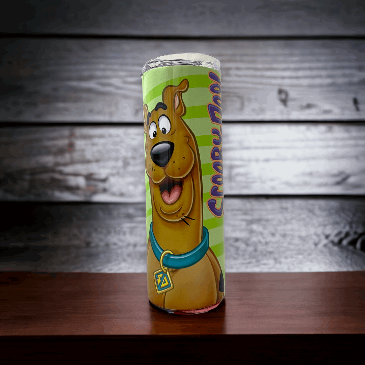 20oz tumbler featuring colorful Scooby Doo design with character image on green background