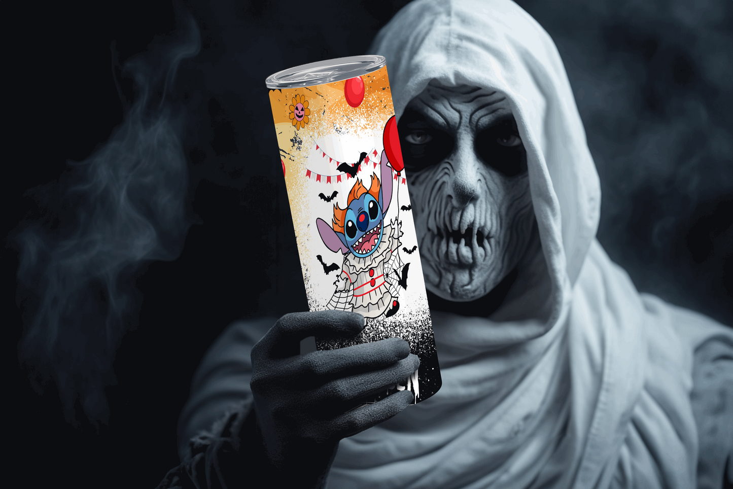 Stanley halloween tumbler 20oz featuring a colorful spooky design held by a person in ghost costume